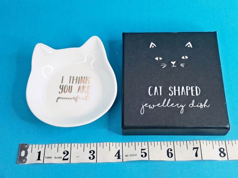 This item is a white ceramic "I Think You Are Puuurfect" cat-shaped jewelry or trinket dish. 