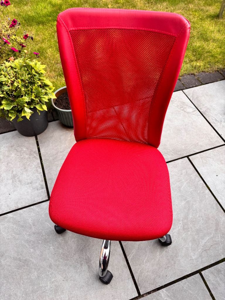 Small Red Desk chair with chrome feet and on casters 