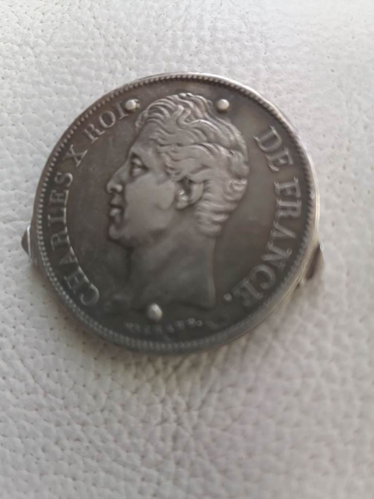 Silver coin of Charles x 1828 sliced and made into tools for ladies nail care. Scissors etc.