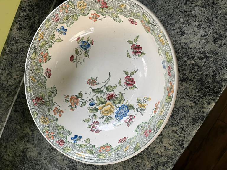 A vintage ceramic bowl with colourful floral design.