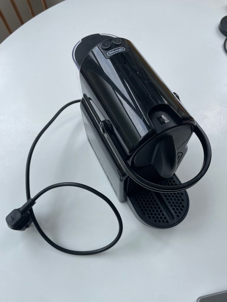 Delonghi nespresso machine + milk frother and coffee pods