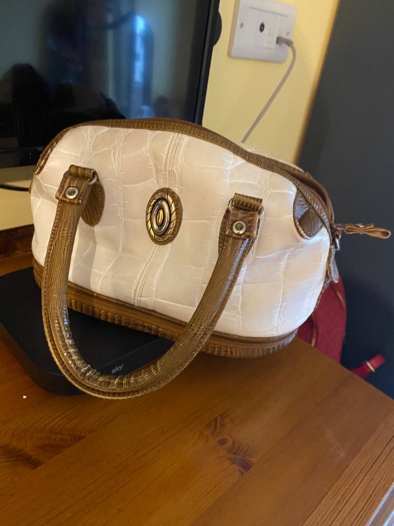 A cute clutch lady's handbag white/brown colour with a hidden zipped bottom/base.