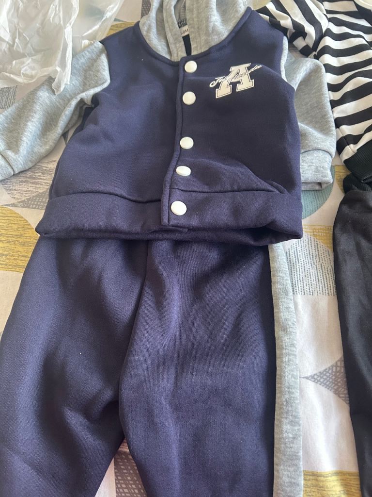 image for Musical baby bouncer with nappies and clothes . 