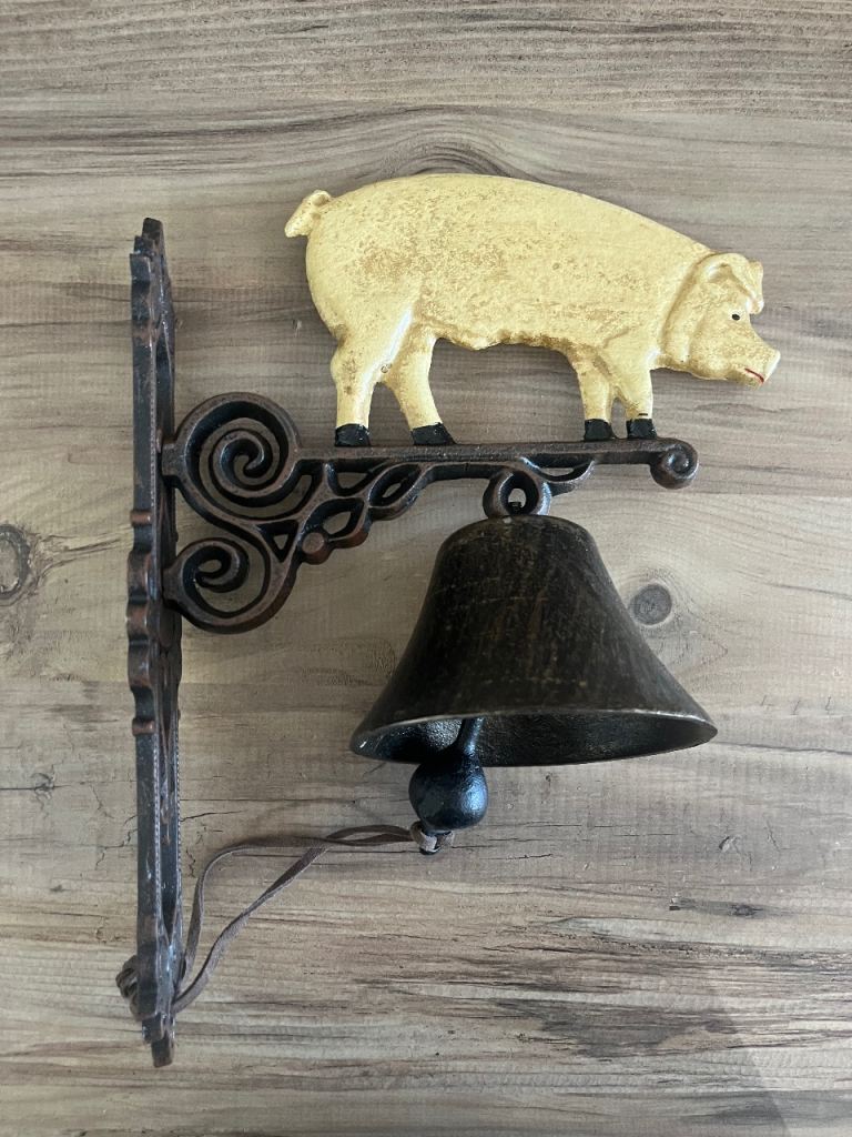 Cast iron wall hanging pig bell