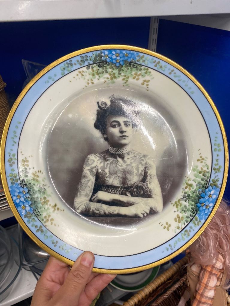 Vintage porcelain plate with tattooed woman