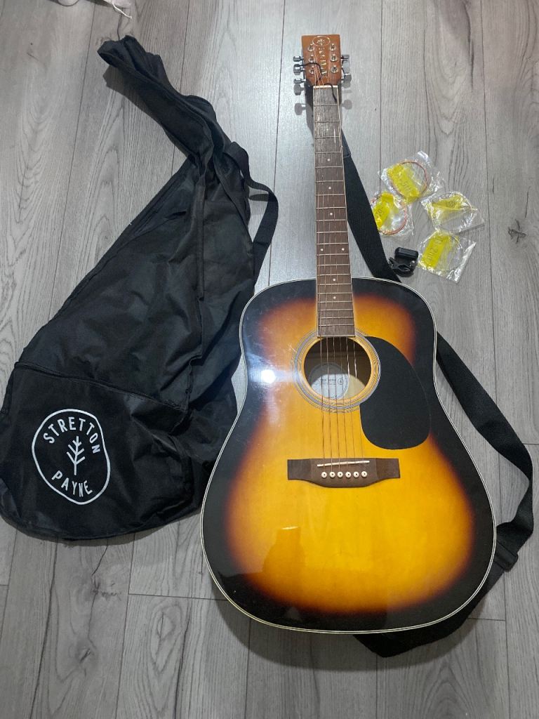 Stretton payne acoustic guitar with case, strings and tuner