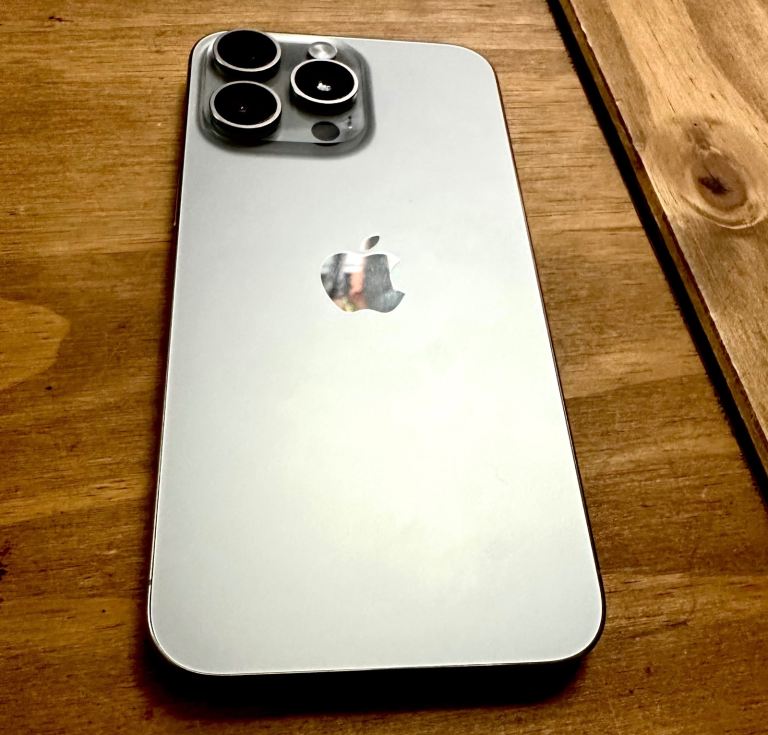 I phone 15 pro max 256gb silver with charger.