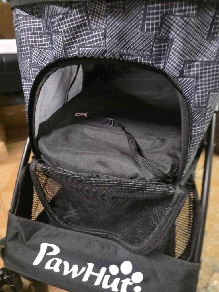 A new grey x black folding pushchair for a small dog it has 3 