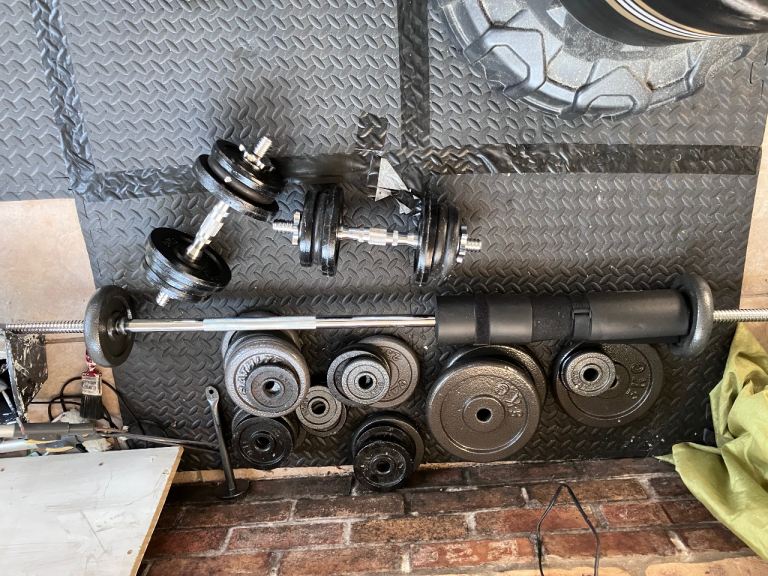 Barbell and dumbbell plus assortment of metal weights 