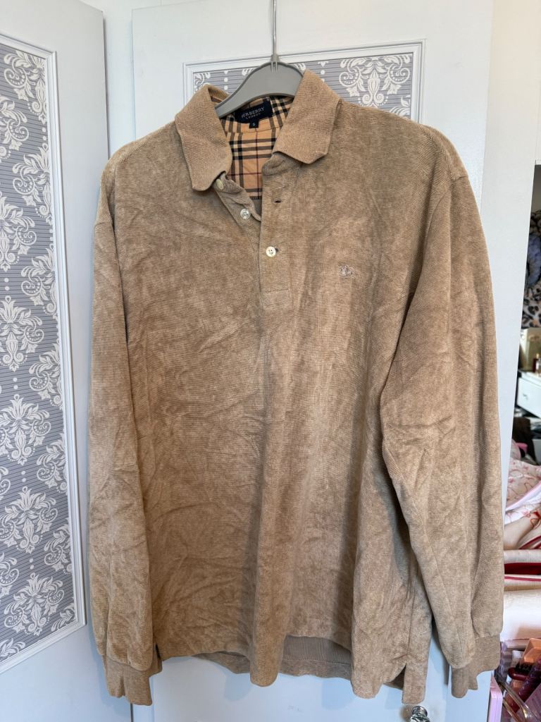 This is a Burberry men's beige corduroy long-sleeve polo shirt. 