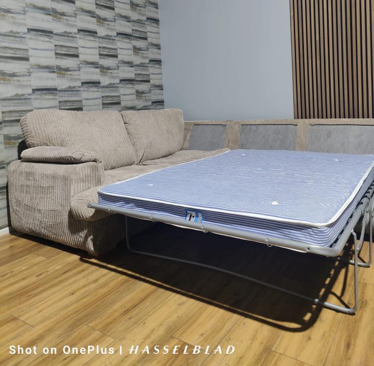 Large beige DFS Corner Sofa Bed  with footstool + free delivery