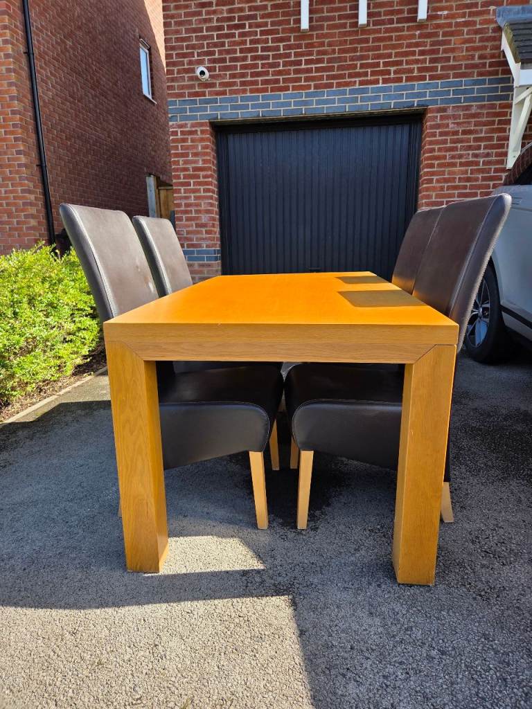 4 seater dining table and leather chairs.