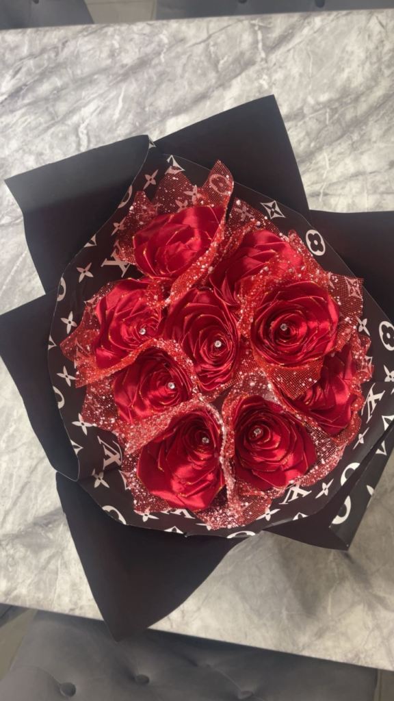 Red roses with diamonds on it wrapped in paper