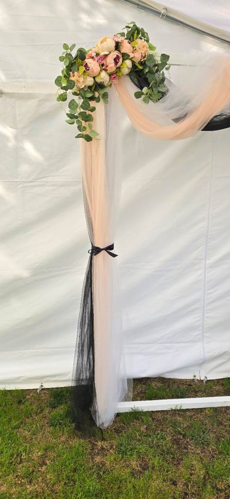Wedding arch backdrop floral voil display.
