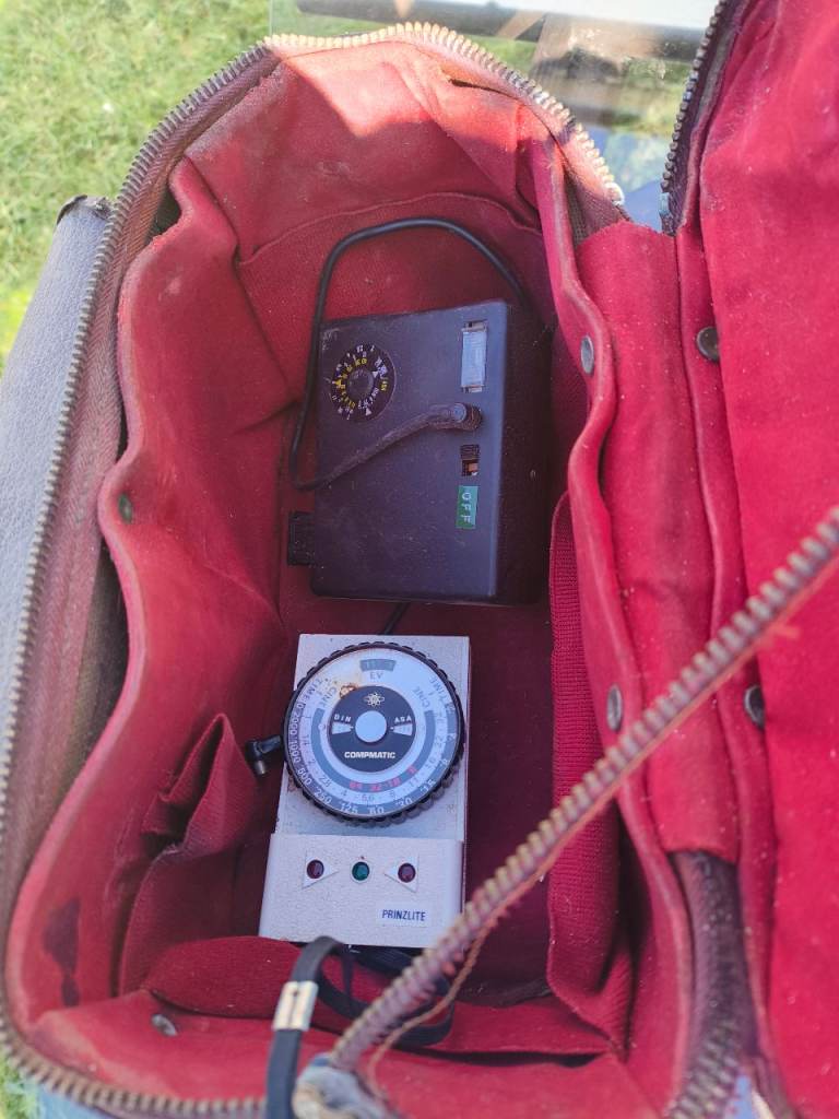 Old camera with case and paper work 