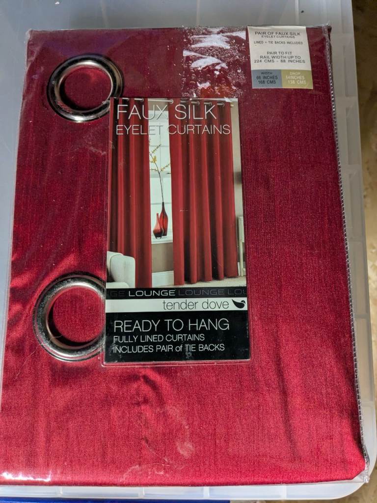 Faux silk red eyelet curtains fully lined with tie backs