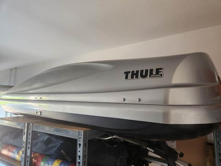 Thule Car roof box, roof bars, and four Thule bike carriers.