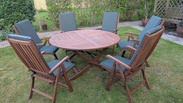 Hardwood Garden Table (5ft/150cm diameter) with Folding Legs, 6 Folding Arm Chairs & Cushions