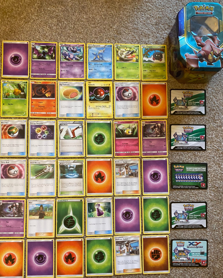 Pokemon trading cards tin, plus a variety of Pokemon trading cards