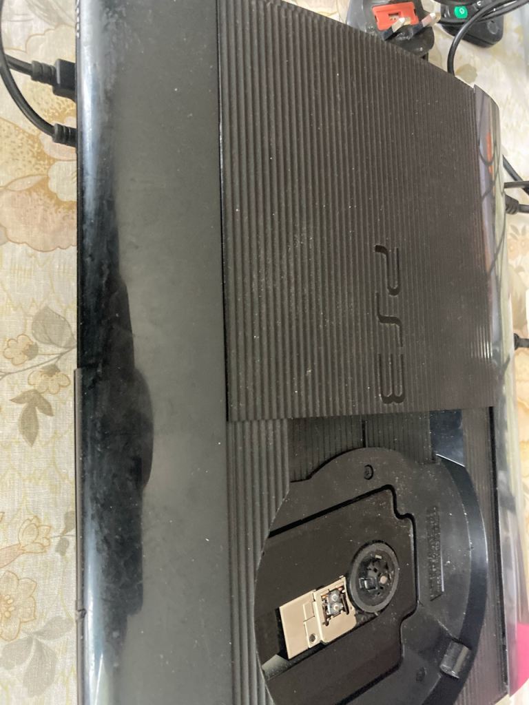 Sony PS3 Player with two controllers and remote devices plus assorted cables 