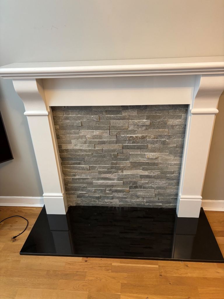 Beautiful white granite fireplace with black hearth