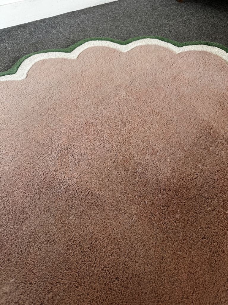 Pink and green scalloped edge rug