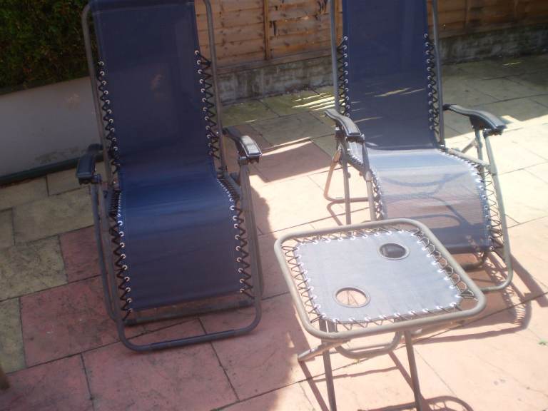pair of sun loungers and table 
