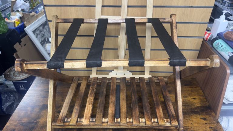 Wooden folding luggage rack with black nylon straps