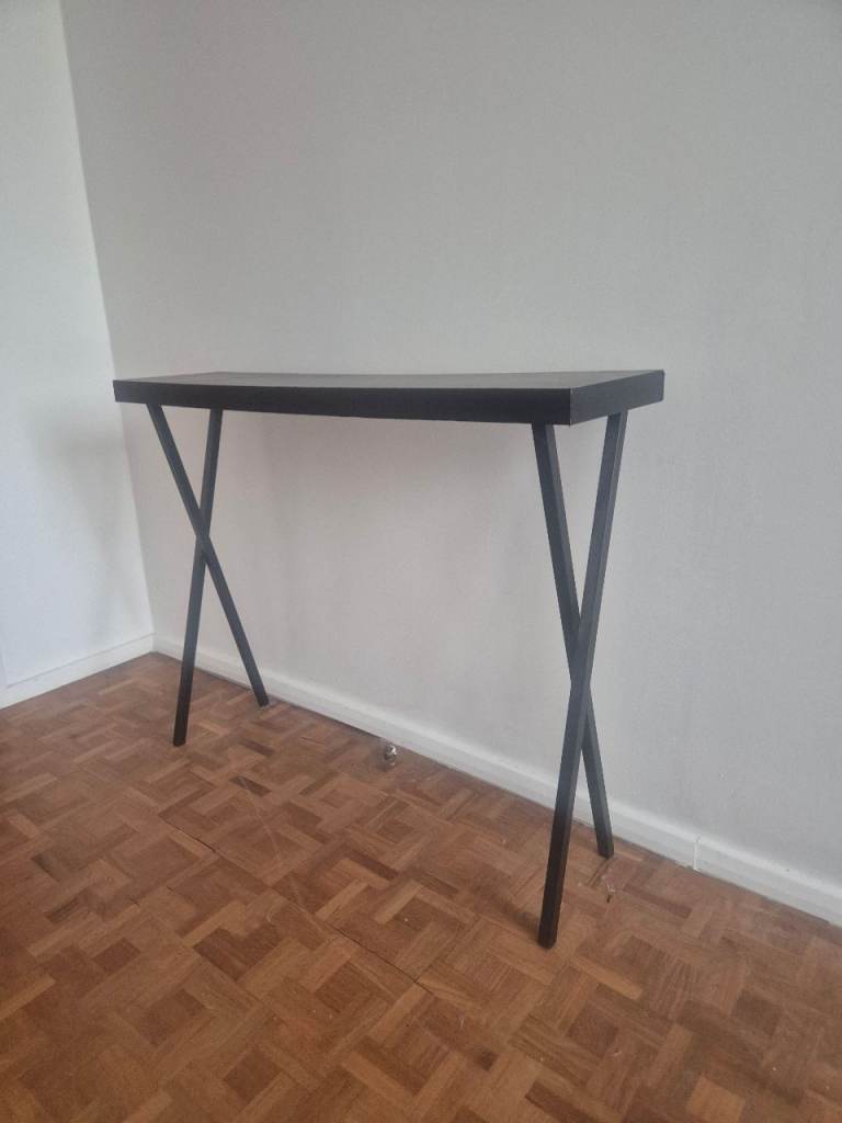 Tall skinny black table (over radiator)
