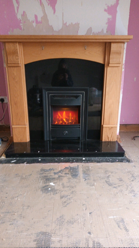 Marble and oak fire Place with electric feature fire. 