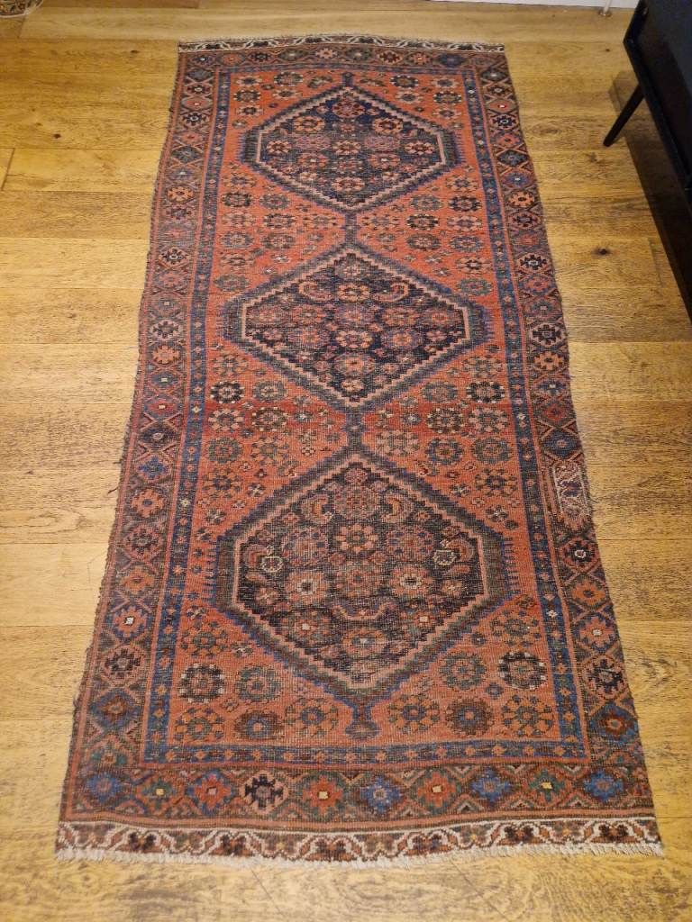 an antique handmade wool persian rug 