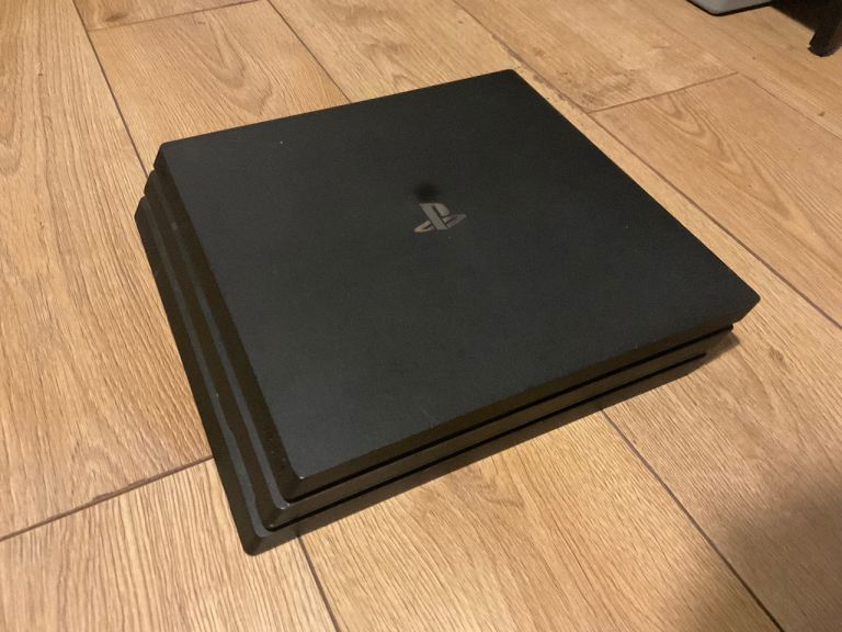 Sony PlayStation 4 Pro Console with Controller and Game