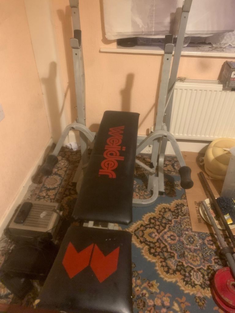 Bench,  metal weights, bars and collars.