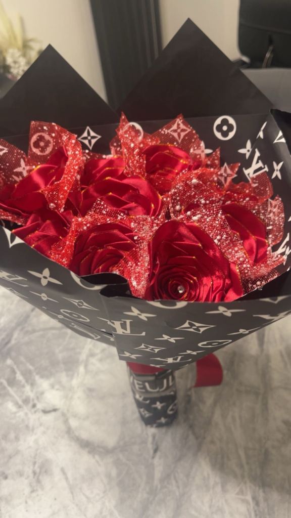 Red roses with diamonds on it wrapped in paper