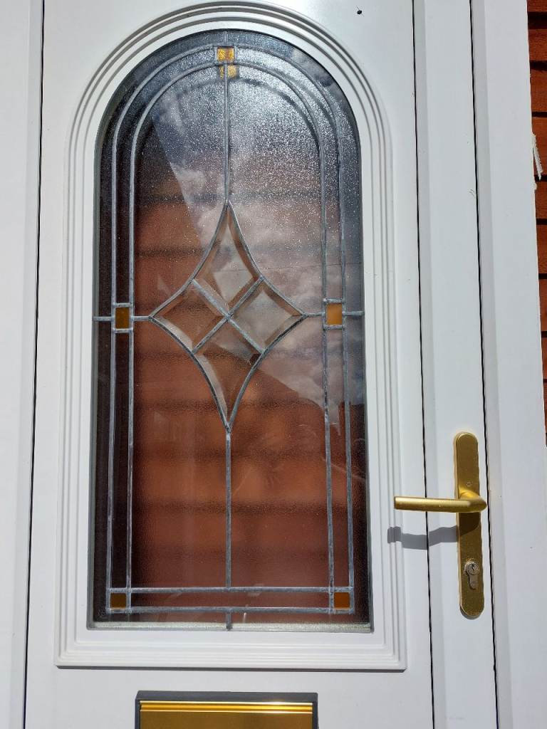 White UPVC Front Door with Decorative Glass and Gold Hardware
