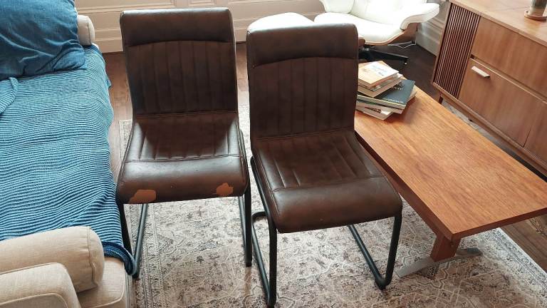 Two faux leather cantilever chairs. 