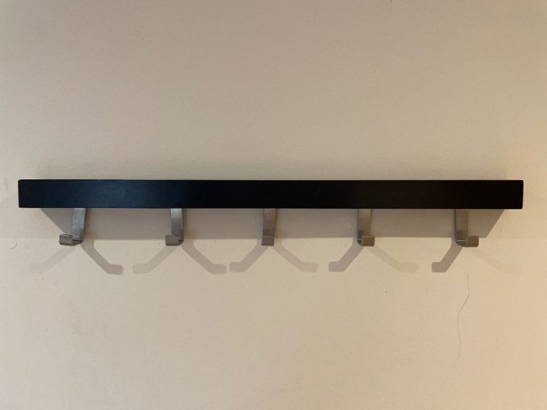 Black Wall-Mounted Coat Rack – Good Condition