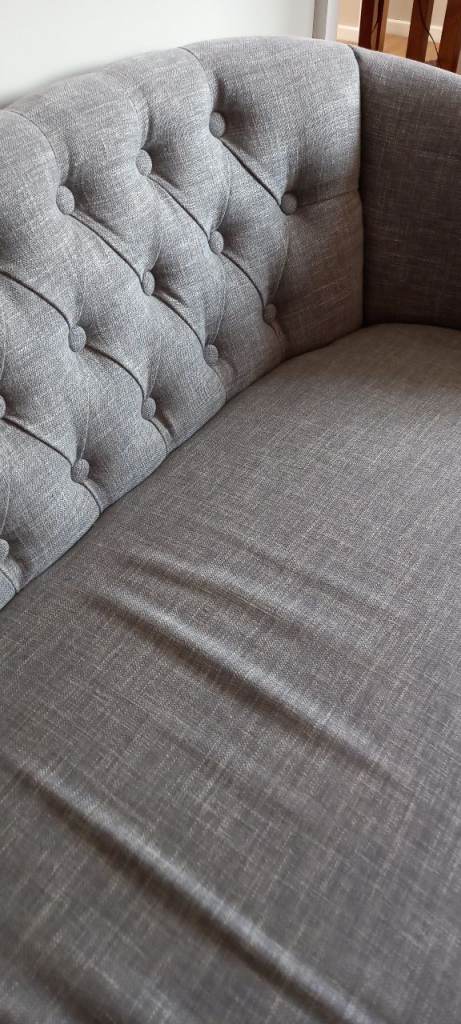 Grey fabric chaise buttoned back