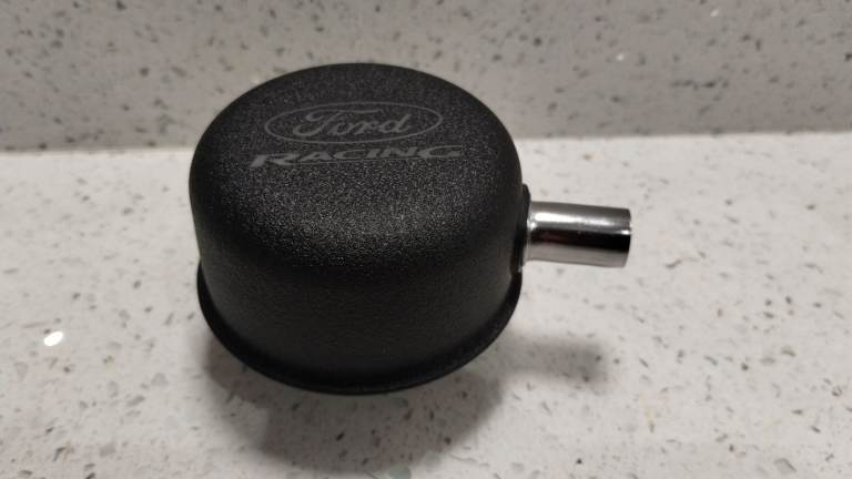 Ford Racing black crinkle rocker cover breather with crankcase breather hose side connection. 