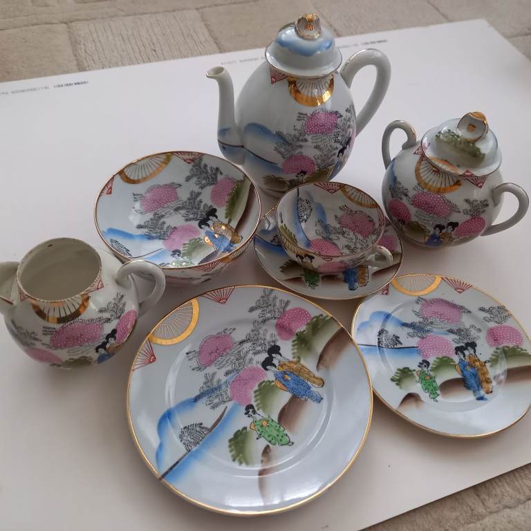 Japanese tea set. Geisha design. Gold and blue colours.