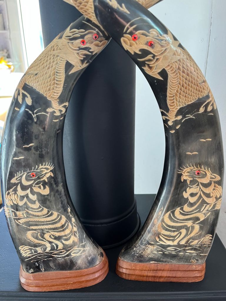 A pair of carved Japanese style horns 