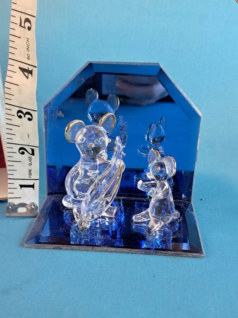 Vintage clear glass mouse figurines with gold-tone accents on their ears.collectible items