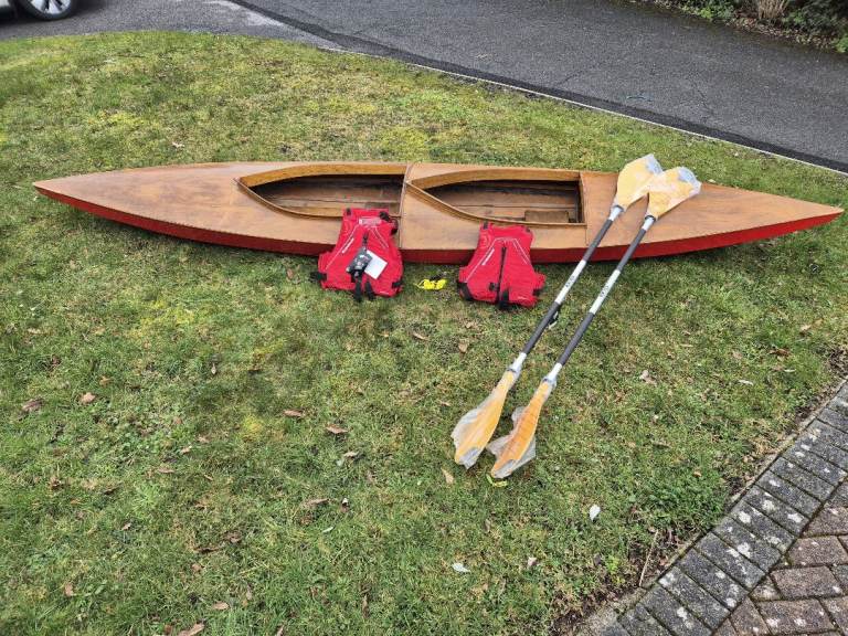 Two man canoe with new unused life jackets and new unused paddles
