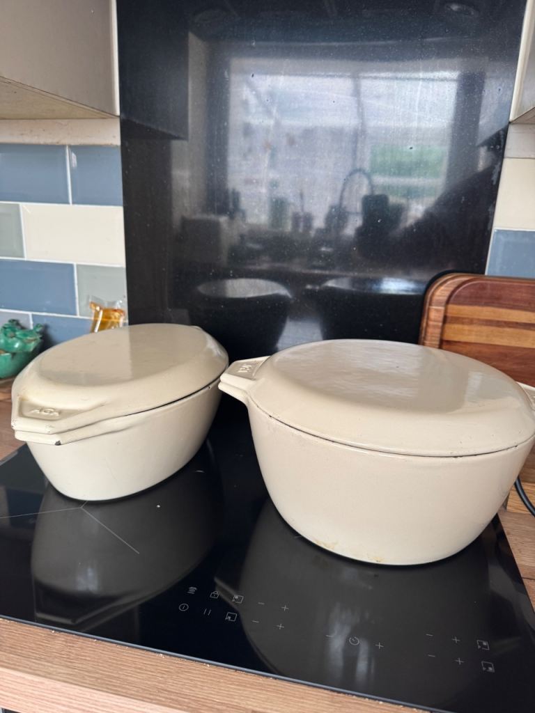 Two original Gypsy AGA cream enamelled cast iron casserole dishes with lids.