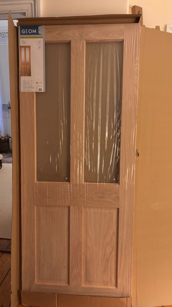 Two internal oak veneer doors with glass panels. 