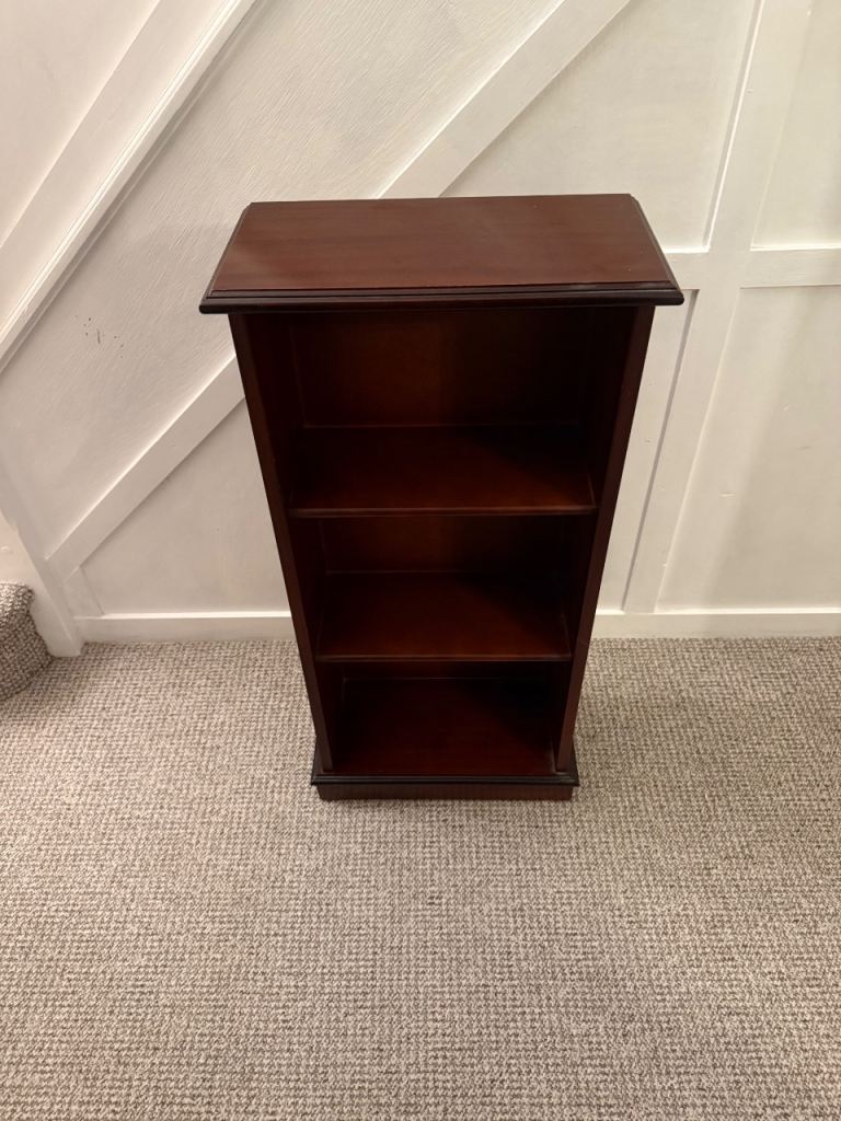 Three shelf, mahogany-finish bookcase