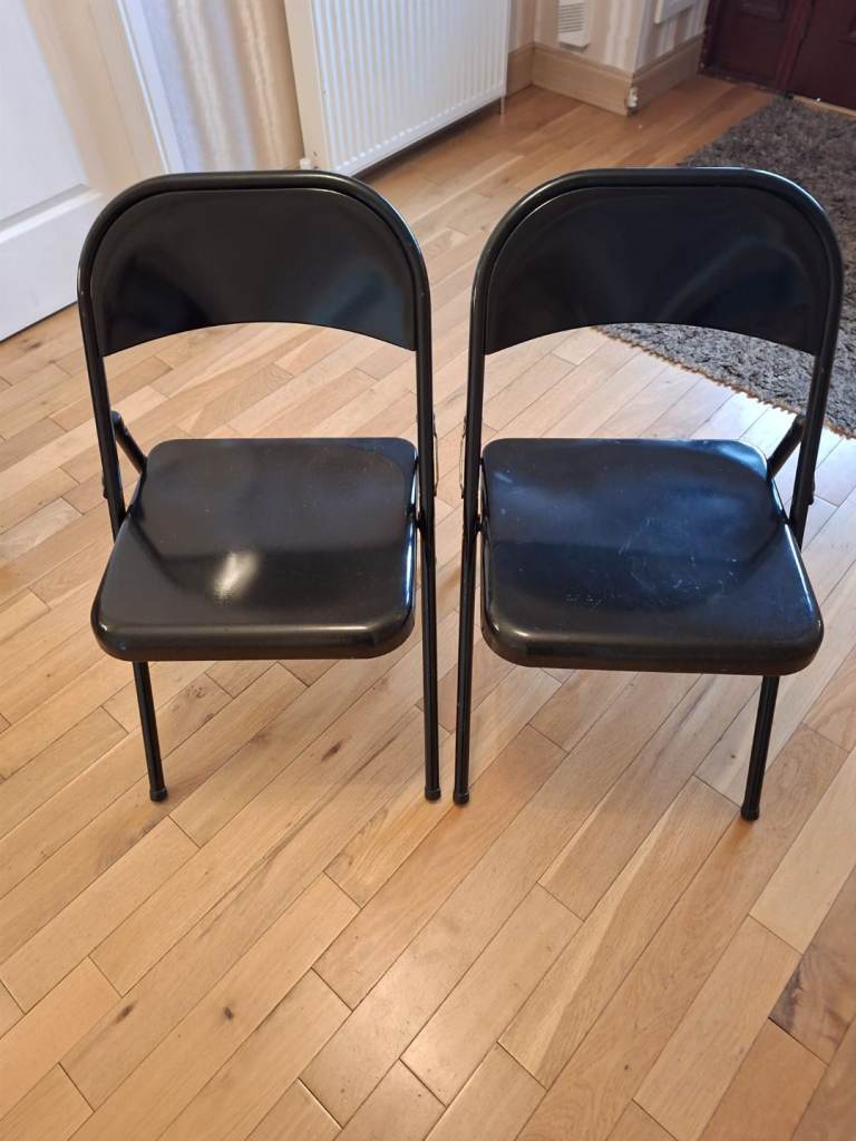 2 black metal fold up chairs 