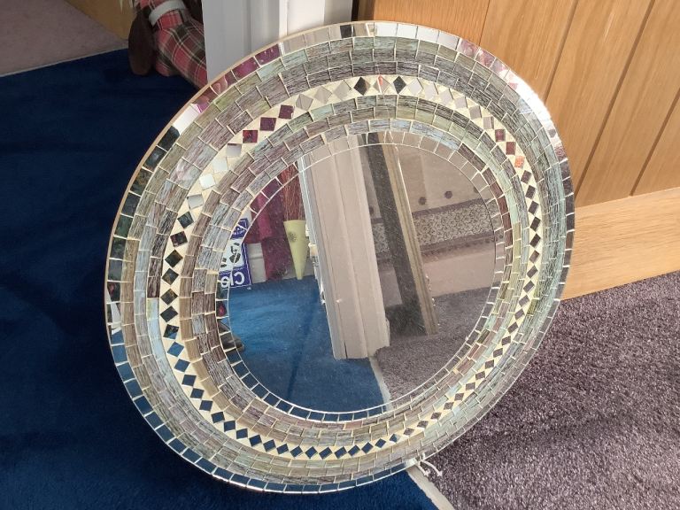 Detailed tiled decorative mirror.