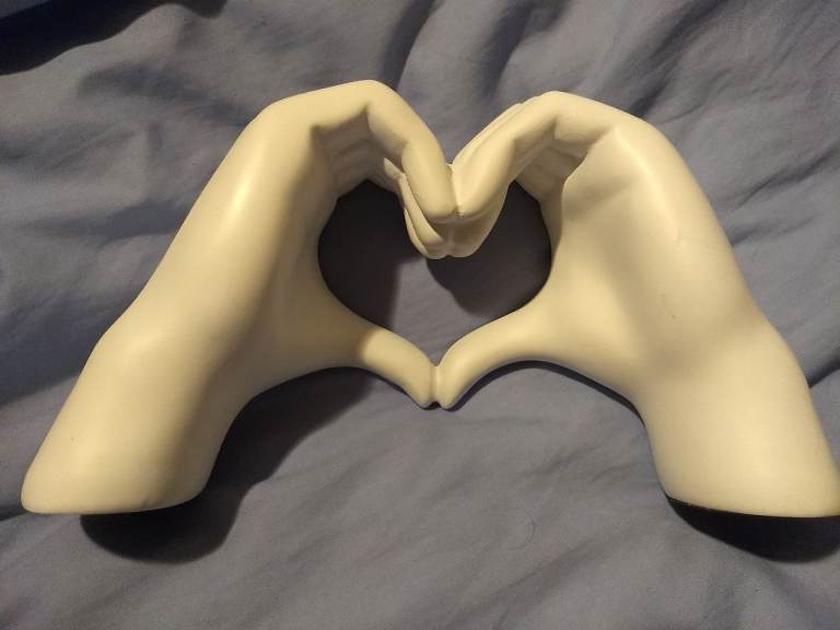 Hands making heart sign ornament