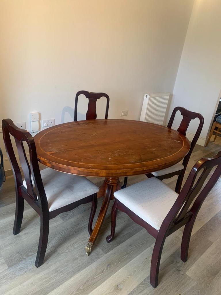 Oval Wooden Dining table with four chairs